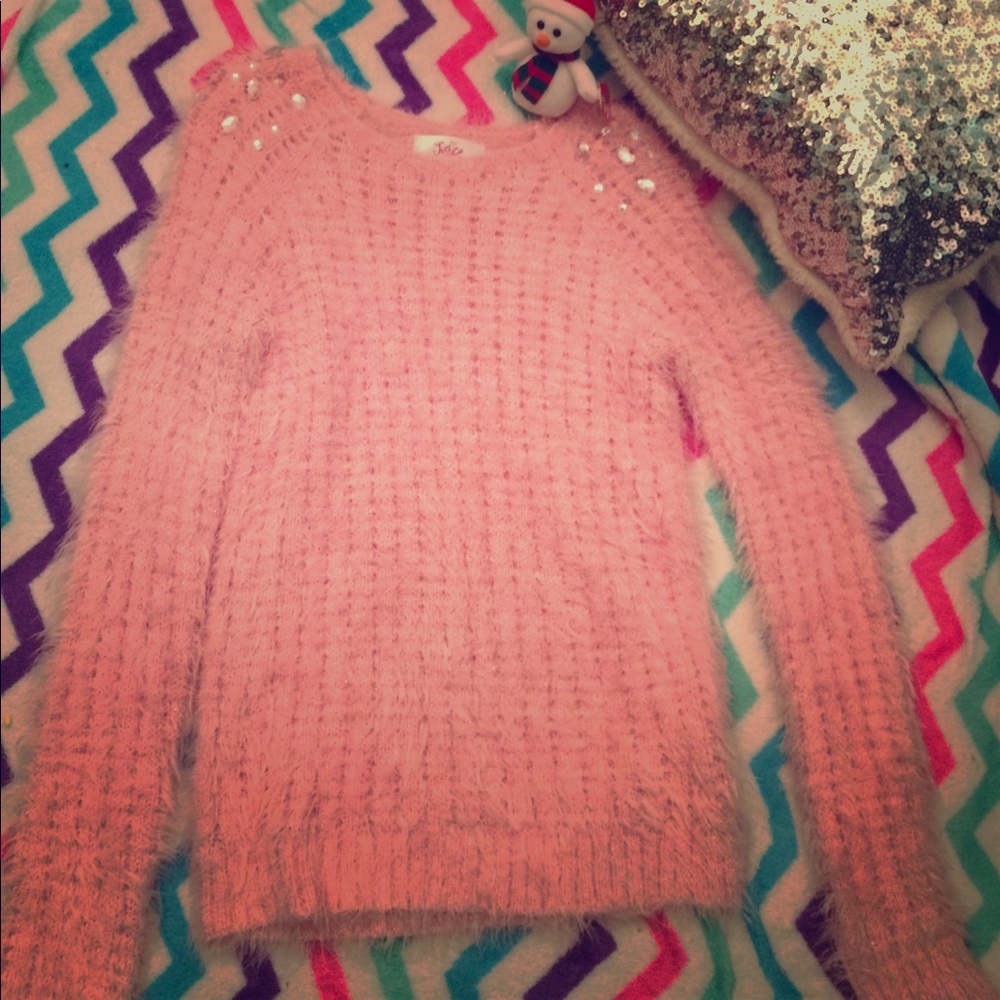 I am selling a light pink sweater.