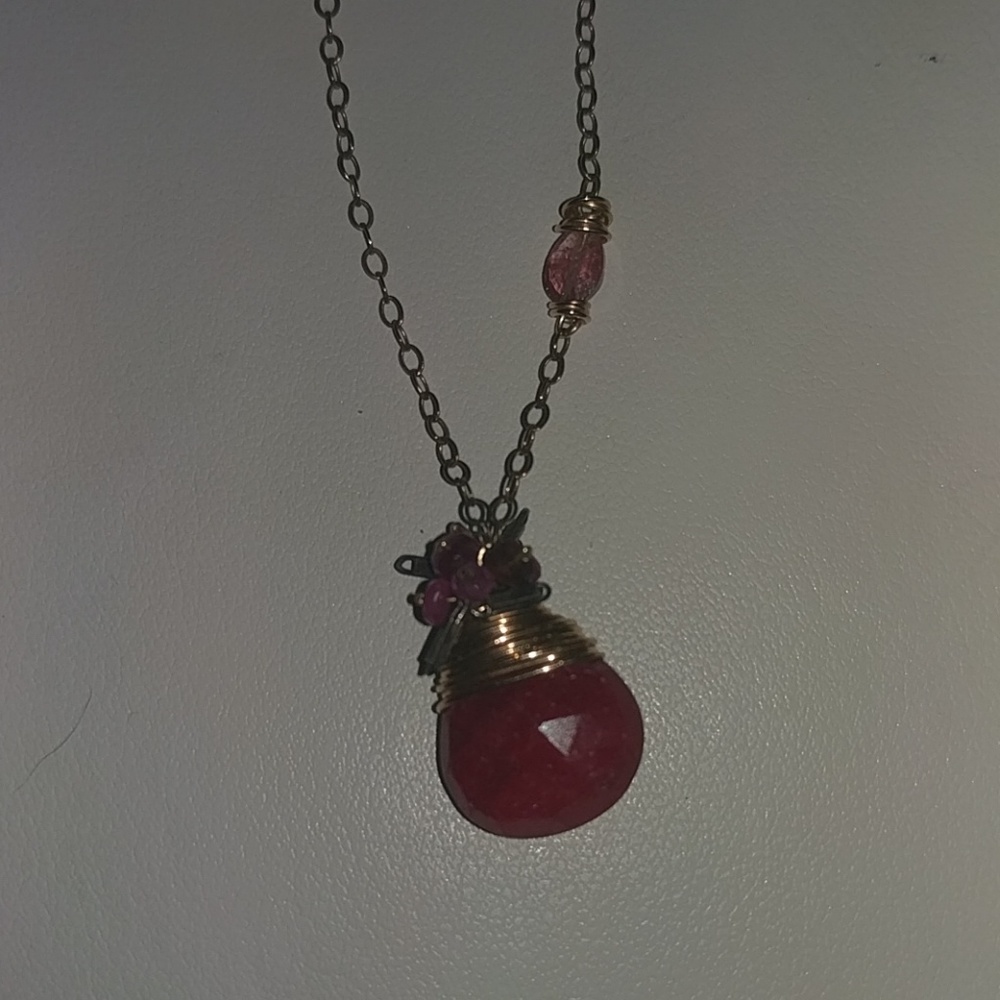 Rough polished cut Ruby with a small Tourmaline