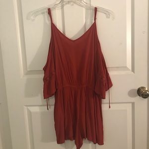 burnt orange romper with a cold shoulder