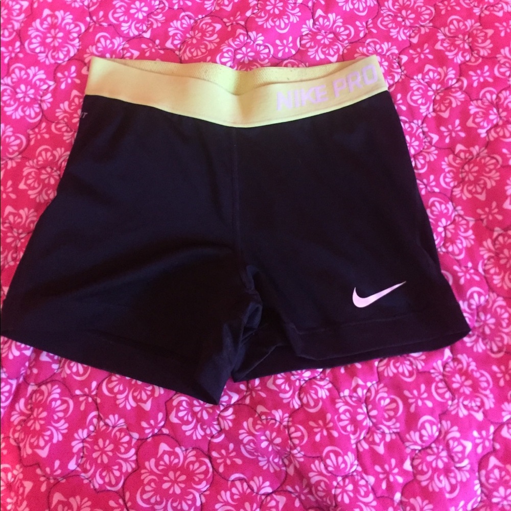 Black nike pros with neon yellow waist band