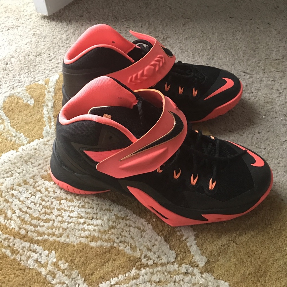 Black and orange Nike Lebron sneakers.