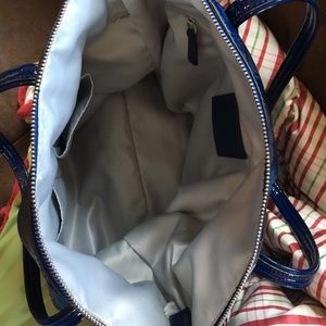 Inside of dark blue Coach bag.