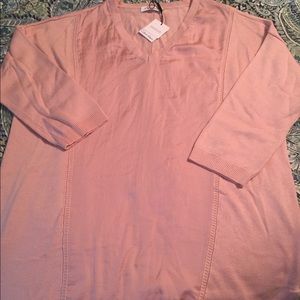 Pale pink Calvin Klein sweater.