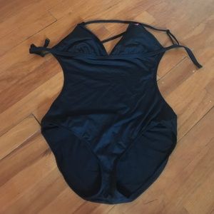 Bathing suit with sides cut out, strap around back