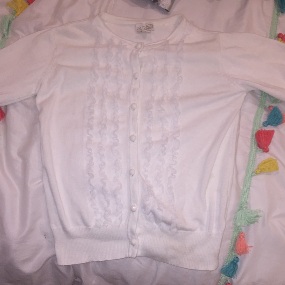 White sweater with ruffles on front