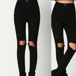 Distressed black skinny jeans