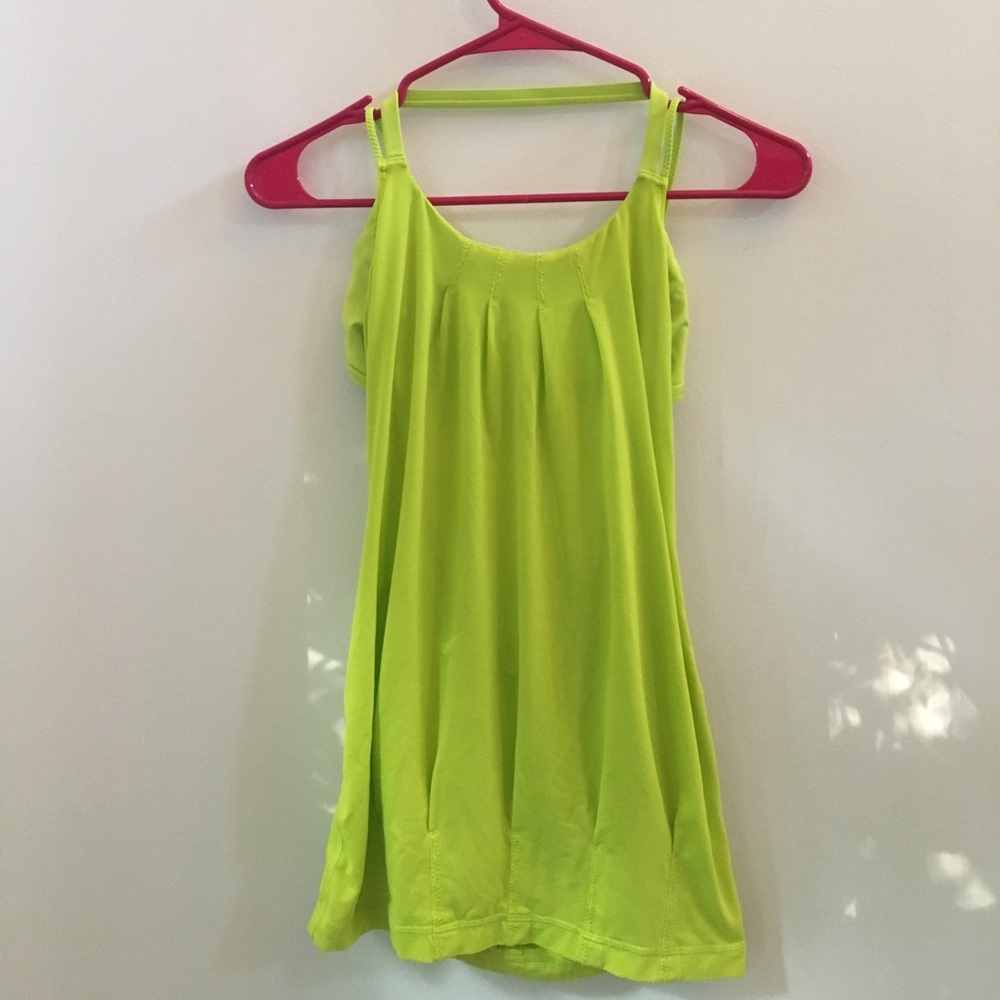 Bright green open cross back lululemon tank top.