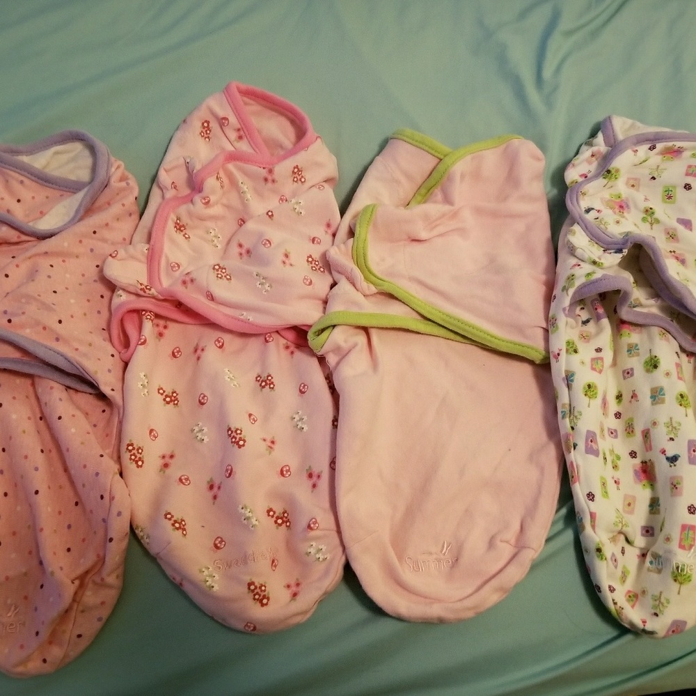 Lot of baby swaddles.  Sm/med