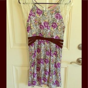 Unique floral dress with lace back accent.