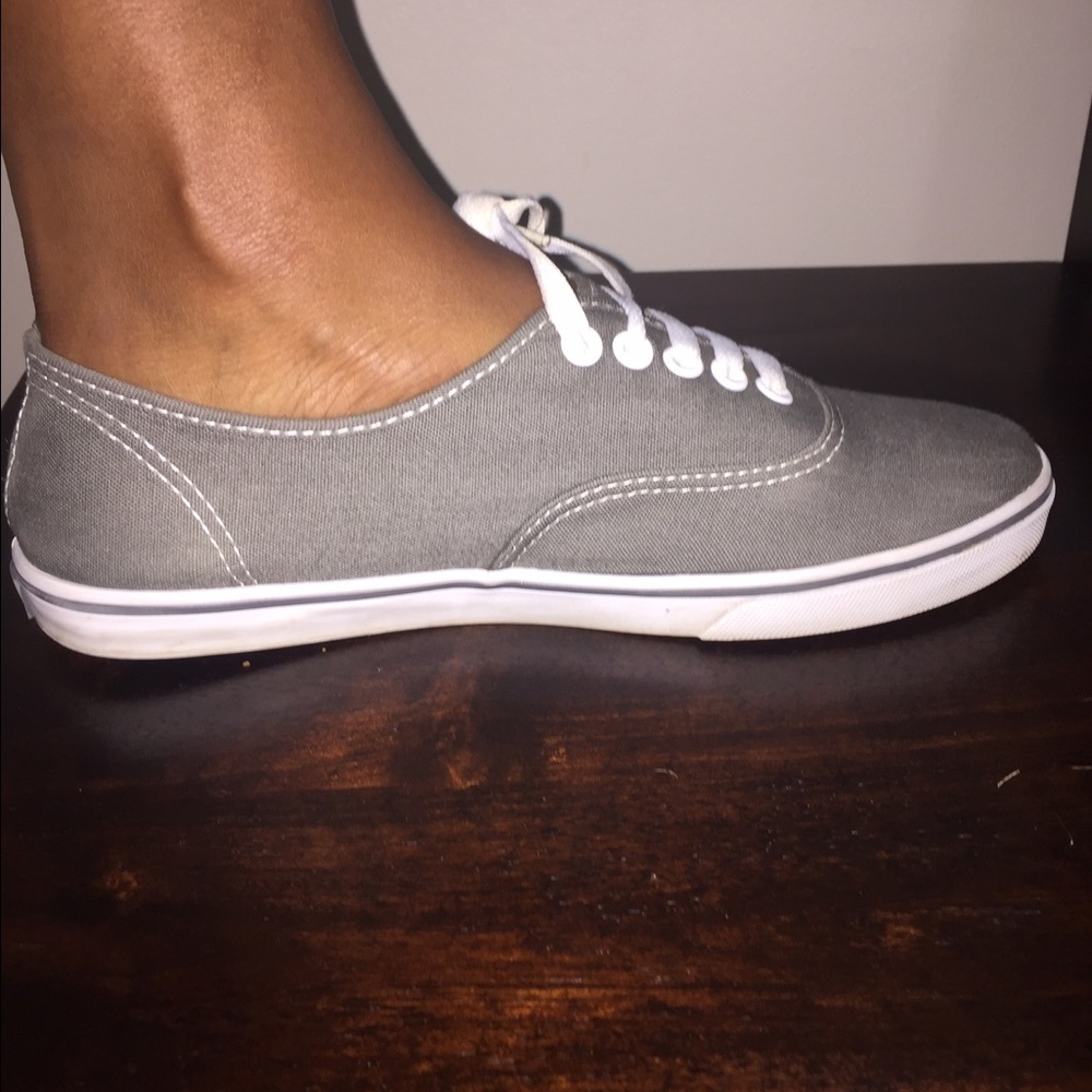 Low top grey and blue vans with white soles