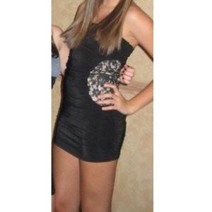 Black strapless minidress with lace cutouts