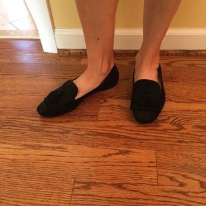 Black tassel and fringe leather loafers.
