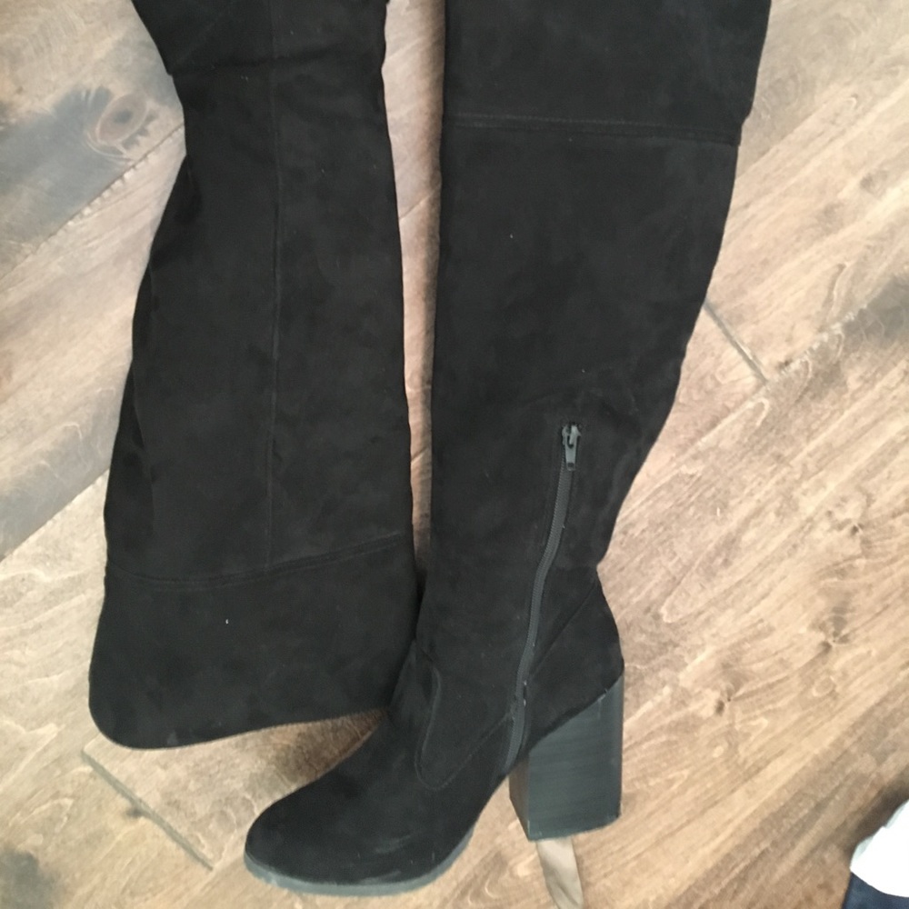 Knee high black boots .