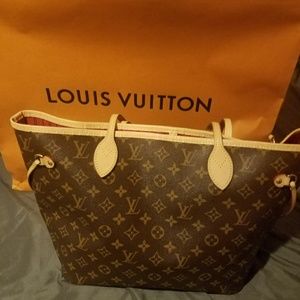 Never full monogram bag with red interior