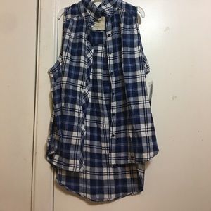 Flannel with no sleeves that plaid blue and white.