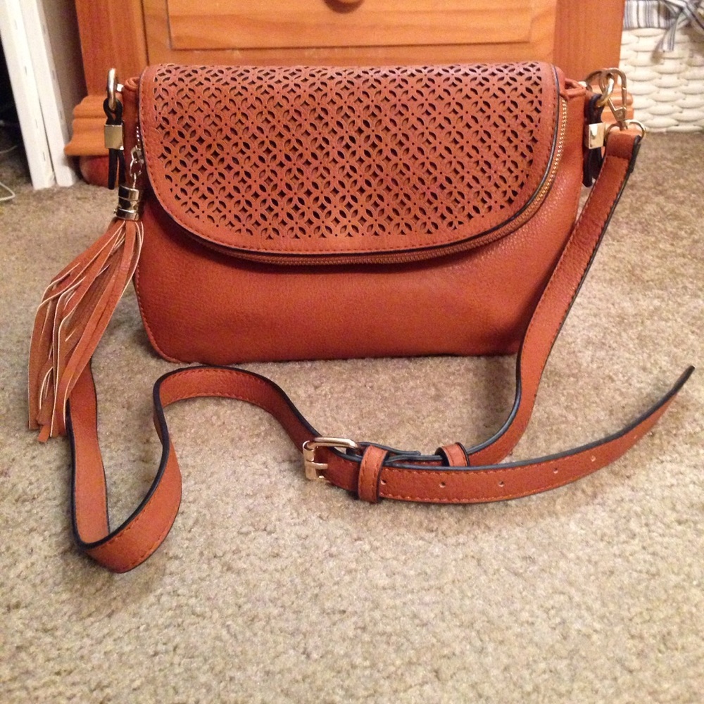 Beautiful brown eyelit accented cross body bag