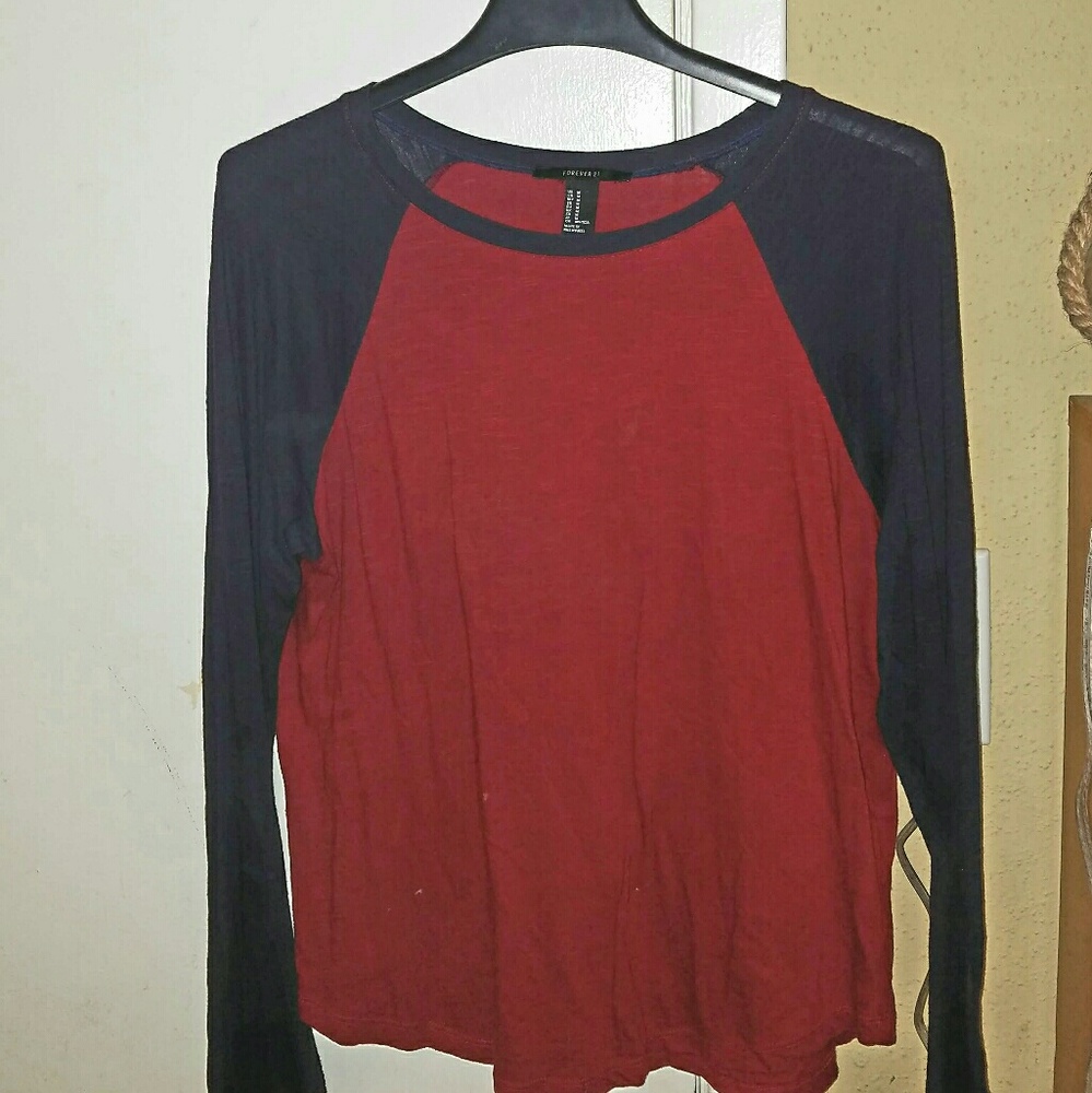 A maroon baseball tee