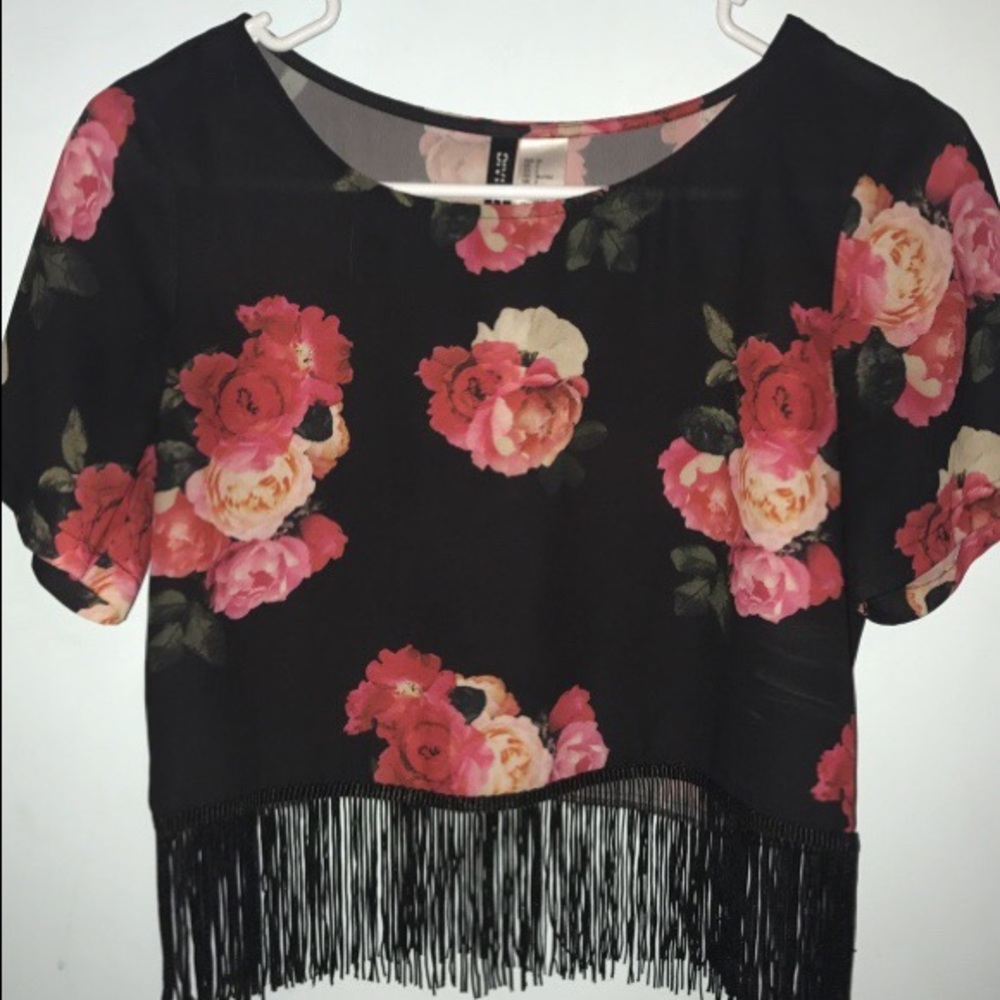 Women's black floral top with fringe.