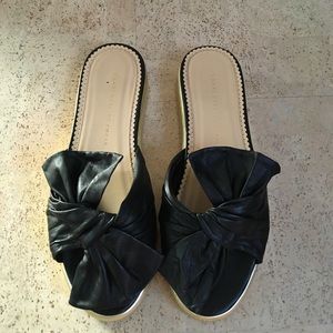 Charlotte Olympia black pool side sliders.