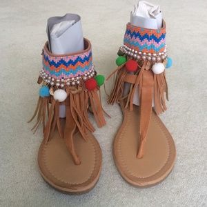 Brand new pair of ankle Pom Pom and tassel sandals