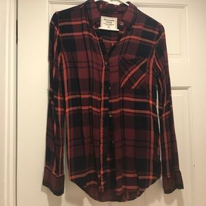 Plaid button down shirt.