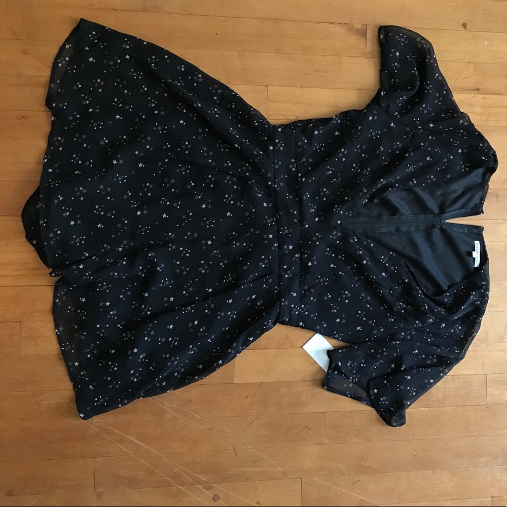 Romper. Zips in back. Low cut in the front.