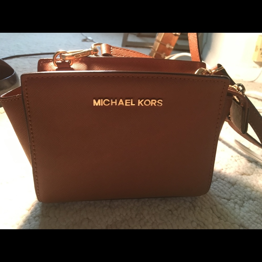 Brown Michael Kors crossbody purse, gold lettering
