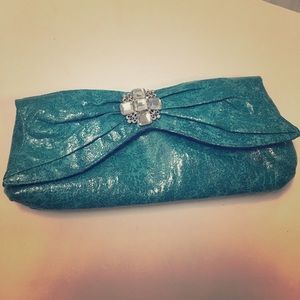 Turquoise clutch with brooch