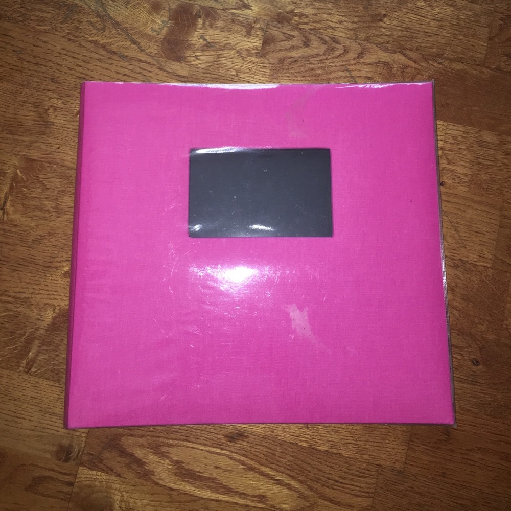 Pink scrapbook with plastic cover still on.