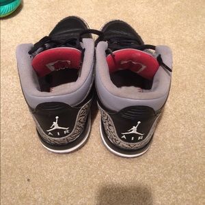 Black cement threes with jump man on back.