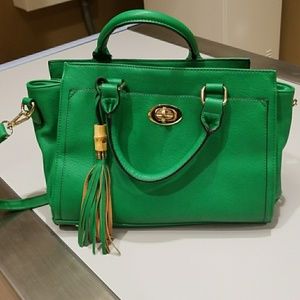 Vibrant green purse with gold tone buckles