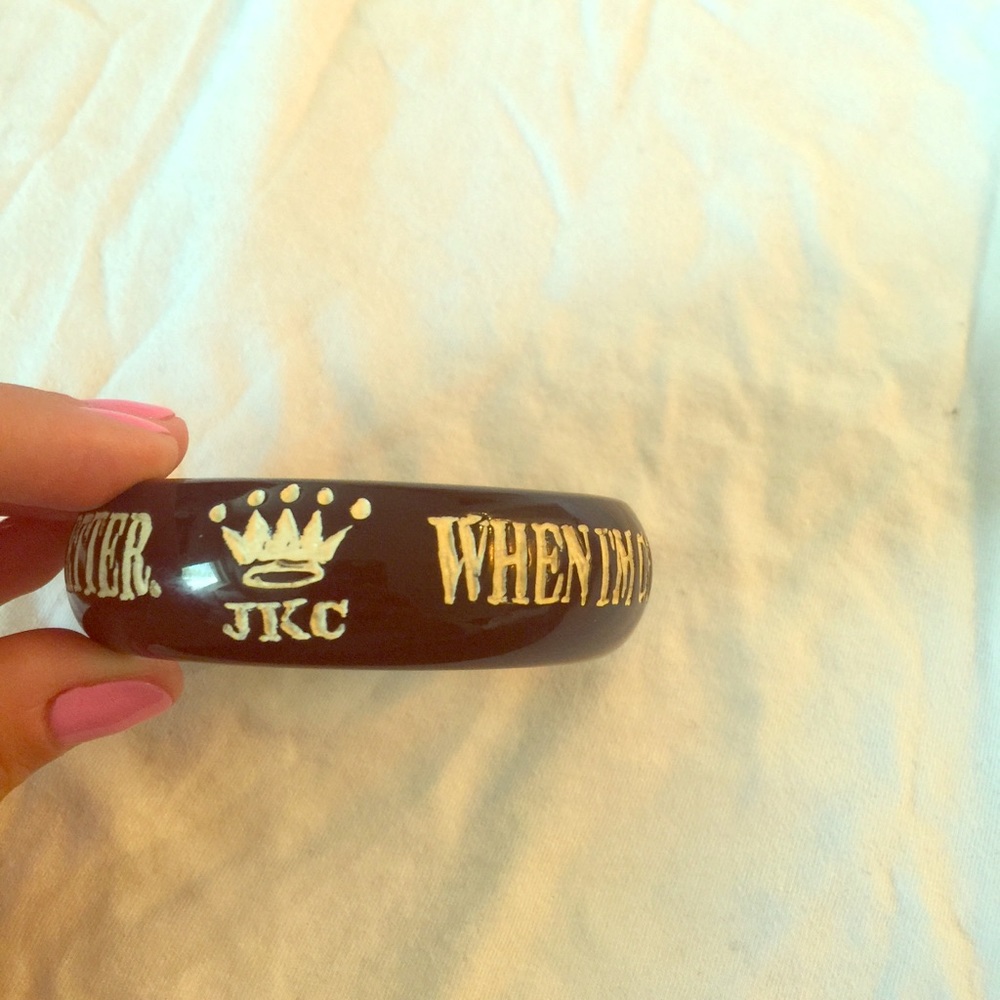 Black plastic bangle with white writing