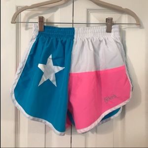 Neon pink, blue, and white running shorts