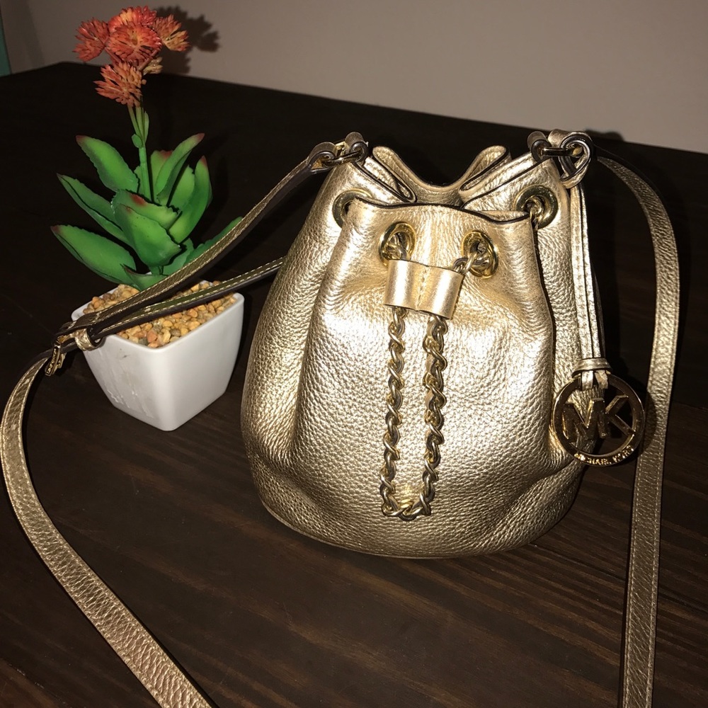 Gold Michael Kors drawstring crossbody purse
