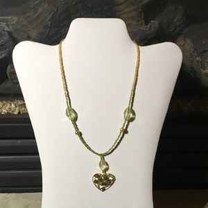 Hand made necklace with gold bird heart pendant