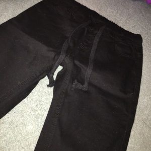 Black drawstring ripped skinny jeans