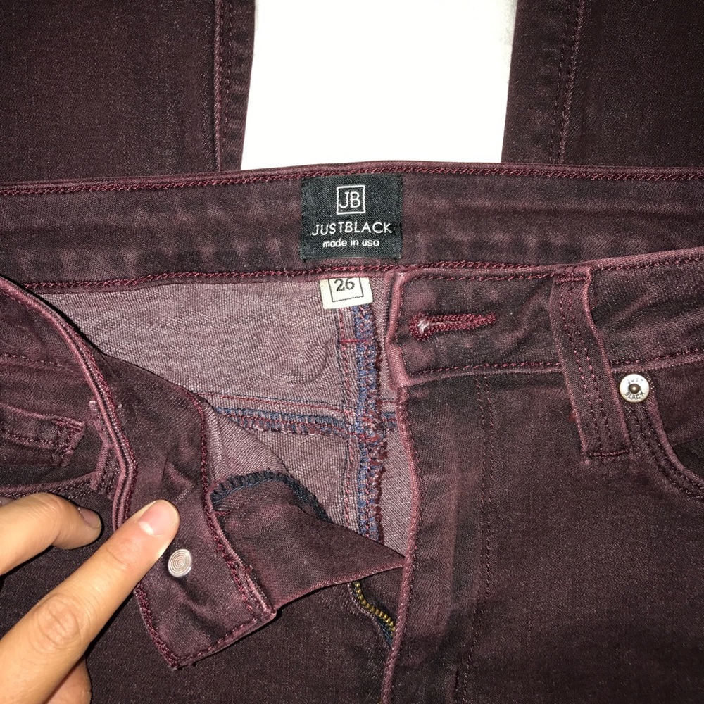 Dark maroon skinny jeans with slits at knees