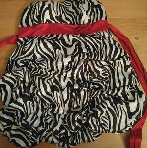 Zebra print with red belt thing with a rose