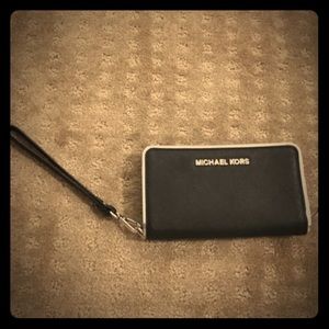 Black Michael Kors wristlet with silver outline
