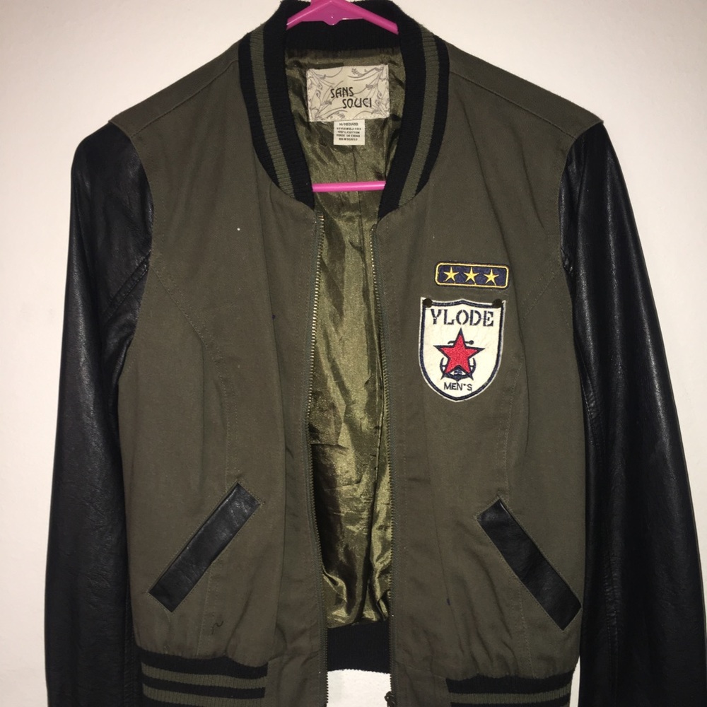 Women's zip up jacket with leather sleeves.
