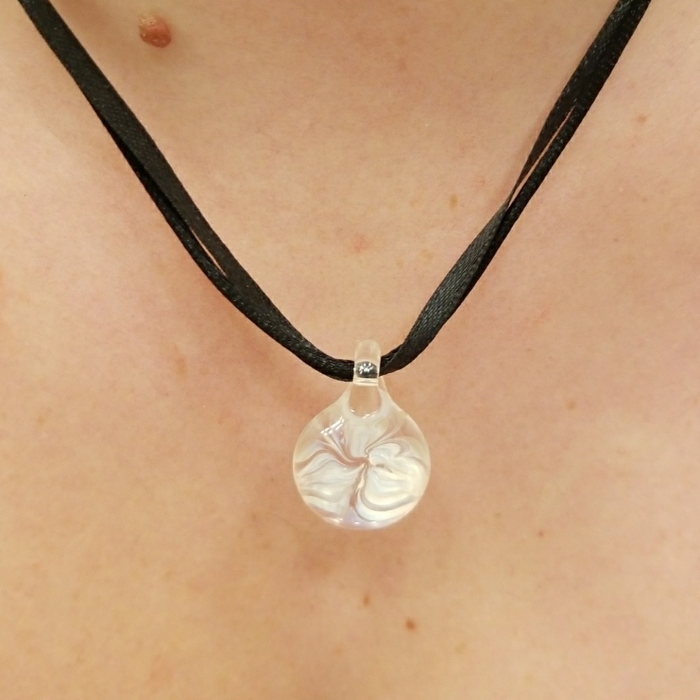 Adjustable string blown glass pendant.
