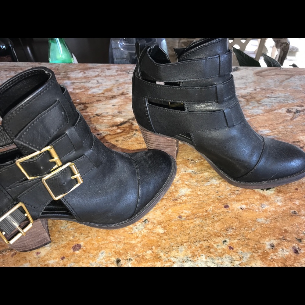 Black booties with gold buckles