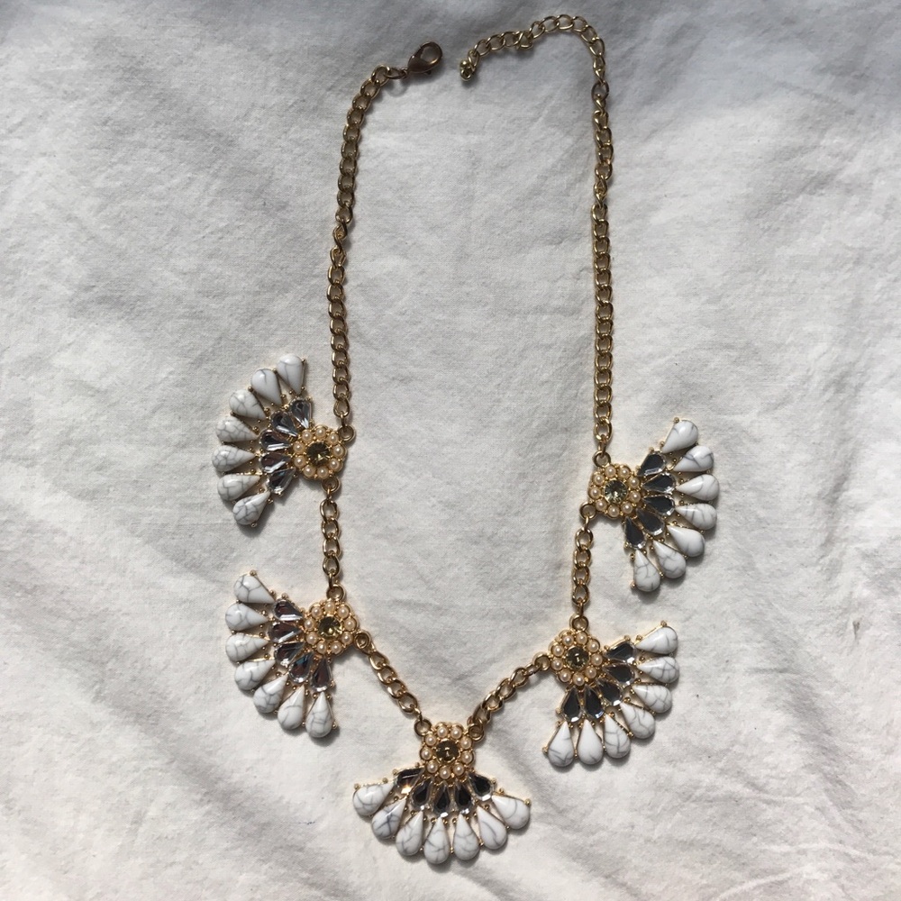 White marble and sparkle bib necklace in gold.