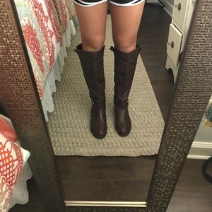 Brown knee high boots.