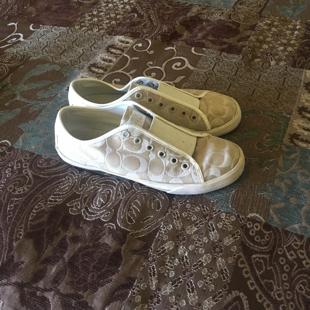 Cream fabric coach shoes.