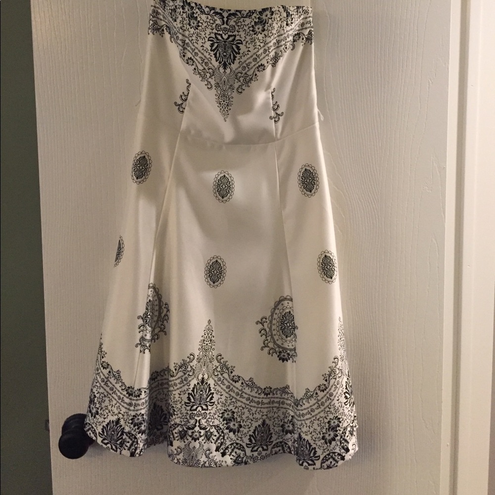 Cream dress with decorative black detail