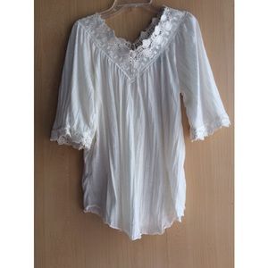 White lacy top, with butterfly sleeves.