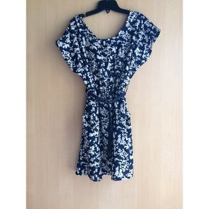 Navy blue dress with white patterns and a belt.