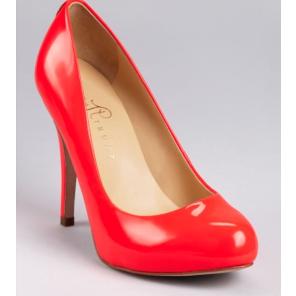 Neon pink patent pumps