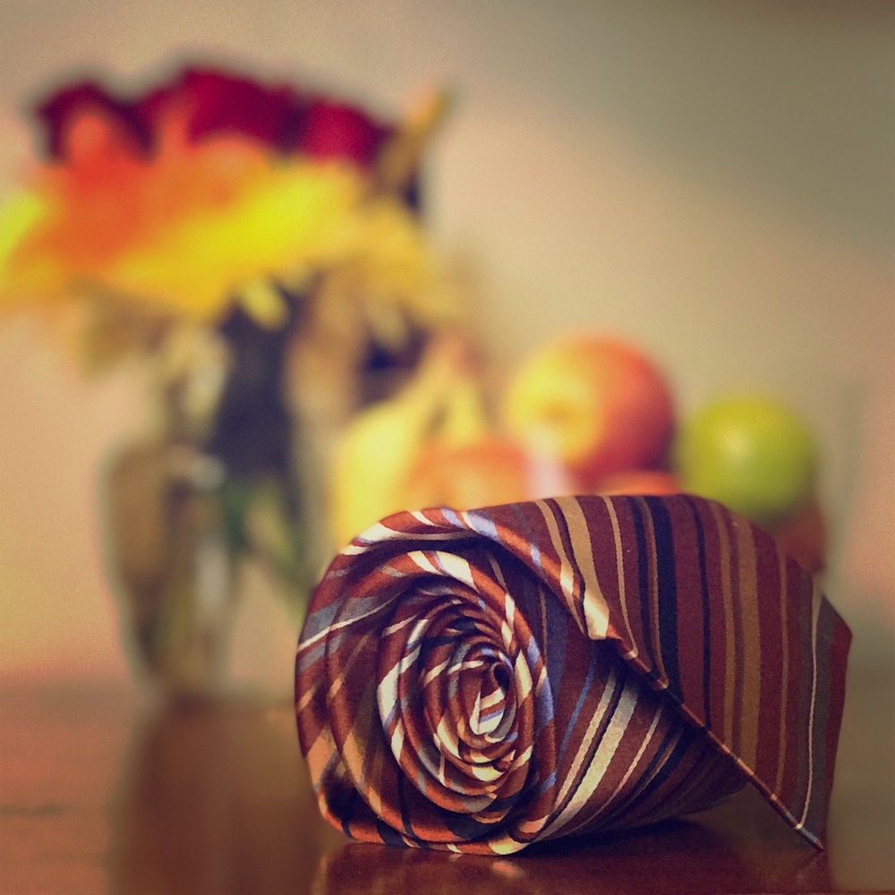 Earth-toned, diagonally striped Geoffrey Beene tie